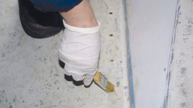 Epoxy resin being used to seal holes in plywood decks on a boat