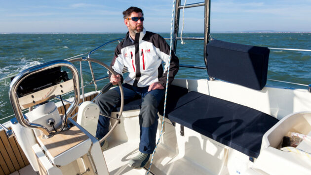 A man helming a Legend 31 sailing yacht