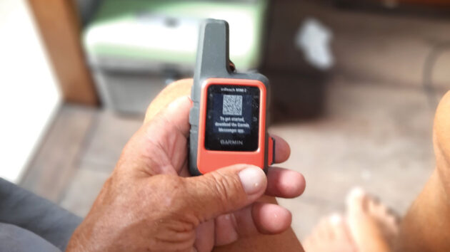 A man holding a Garmin Inreach