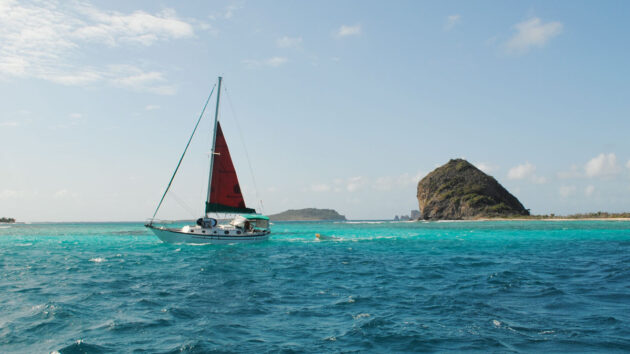 A boat sailing past Mushroom island while sailing an Atlantic Circuit