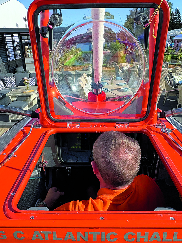 Andrew Bedwell sitting inside his 100cm boat, Big C