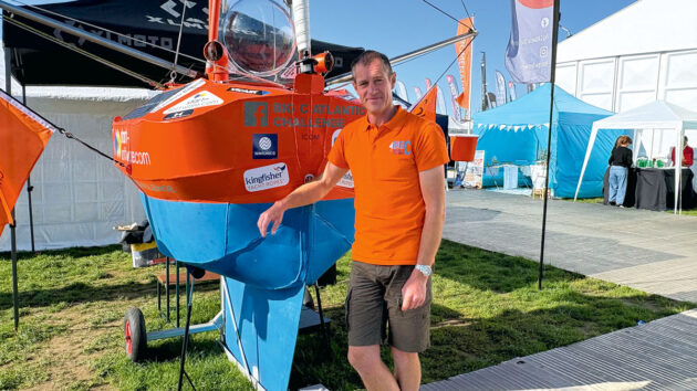 Andrew Bedwell standing next to his microyacht Big C V2