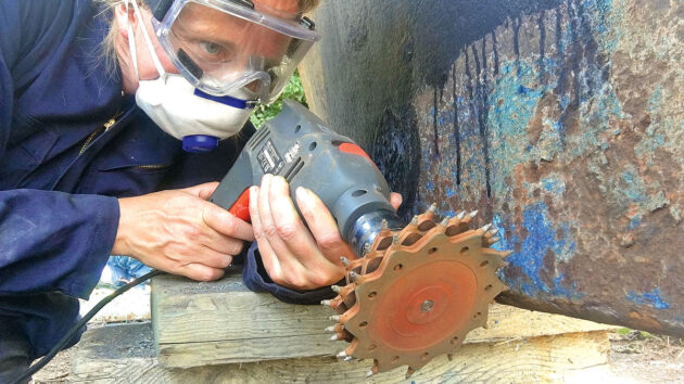 A woman working on a boat keel