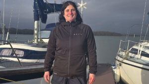 A woman wearing a Musto Evo Therm Primaloft jacket on a pontoon
