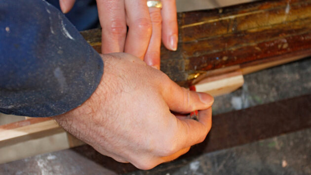 A man making a tiller for a boat
