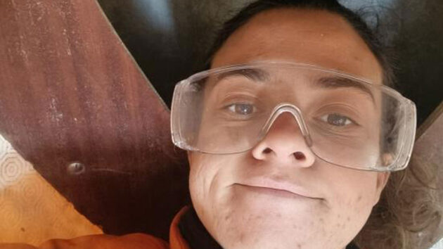 A woman wearing oversized protective eyewear while boat building