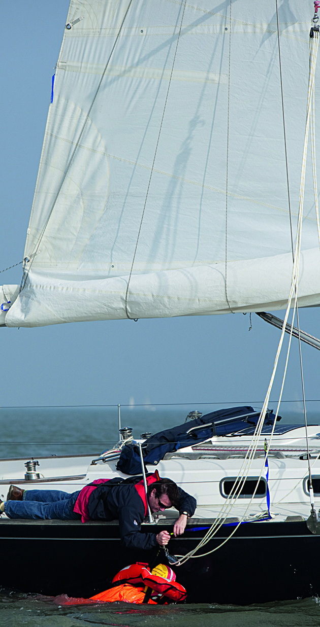 A man demonstrating a MOB recovery from a boat
