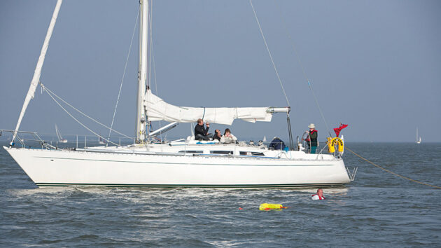 A yacht rescuing a man overboard