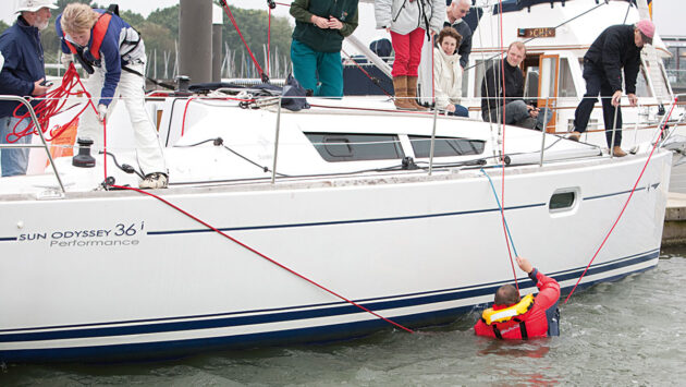 A man demonstrating MOB recovery on a yacht