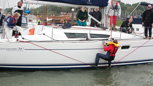A man using a line to get back on a boat
