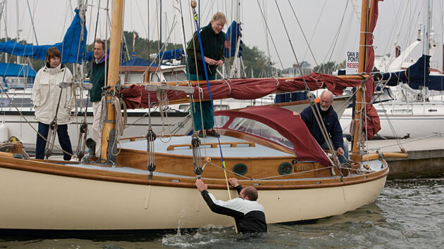 A man climbing onto a boat