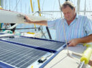 A man looking a boat solar panels