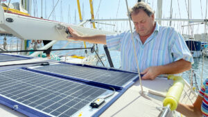 A man looking a boat solar panels