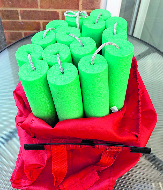 green pool noodles in a red bag