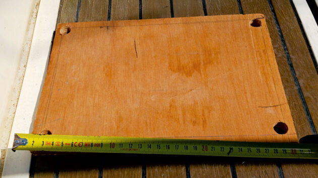 A piece of wood being used to make a boat step