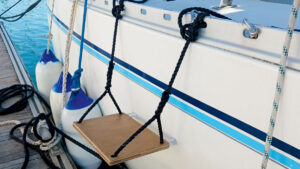 A boat step rigged to the side of a yacht on a pontoon