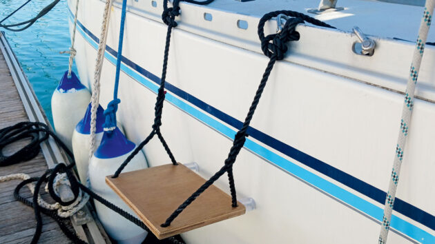 A boat step rigged to the side of a yacht on a pontoon