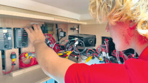 A man looking at boat electrics