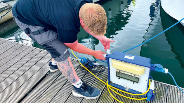 a man connecting shore power for a boat