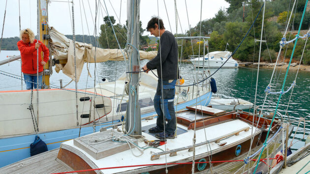 a person preparing a boat mast for unstepping