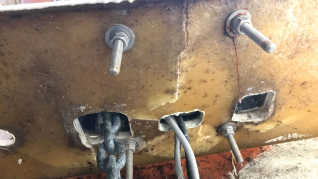 A cracked boat deck underneath an anchor windlass