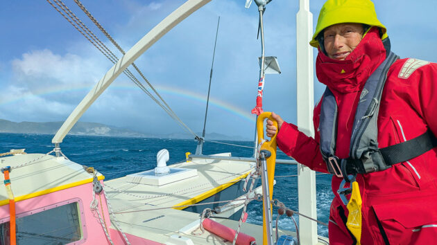 A woman at the helm of China Moon, a catamaran designed by Pete Hill