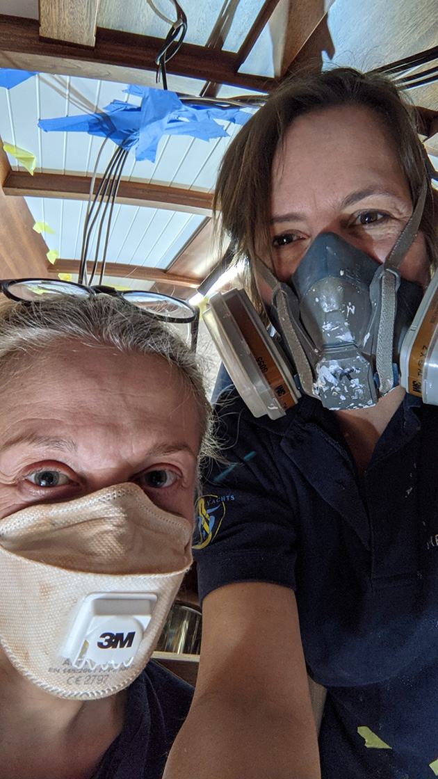 Women boatbuilders wearing respiratory protective equipment as part of their PPE