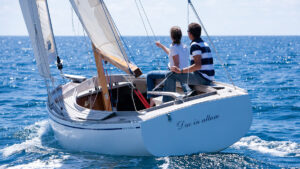 Two people sailing a Grand Cormoran boat