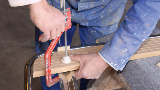 A man using clamps to make a boat swimming platform