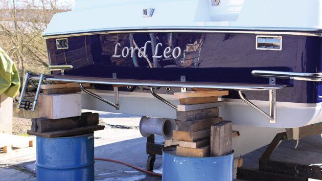 A boat swimming platform on blue barrels ahead of fitting to a motorboat