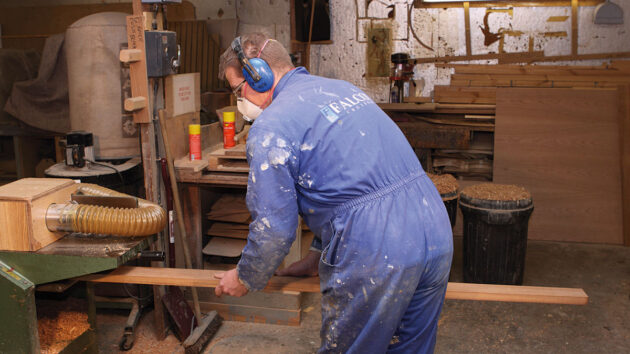 A man doing woodwork in a workshop