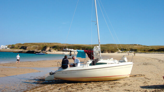 A boat drying out on sand