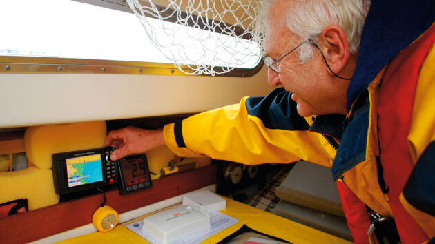 A man checking the chartplotter on a yacht