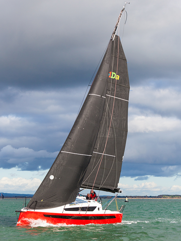 A man at the helm of a w1DA yacht