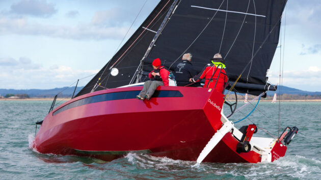 A w1Da yacht being sailed under a cloudy sky