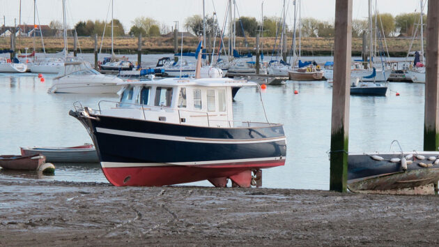 A motorboat drying out on a beach