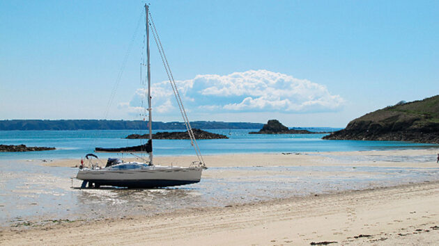 A yacht moored on a beach
