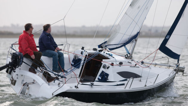 2 people sailing a Storm 22 yacht