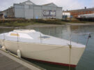 A boat next to a pontoon with no deck gear