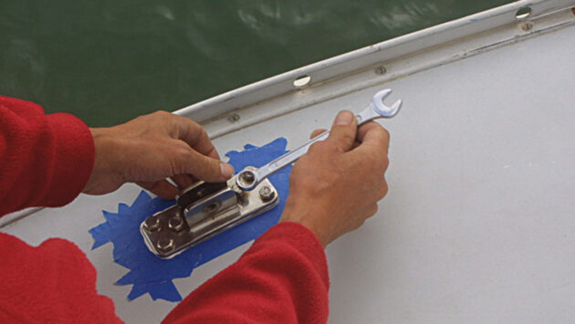 A man using a spanner to fit deck gear