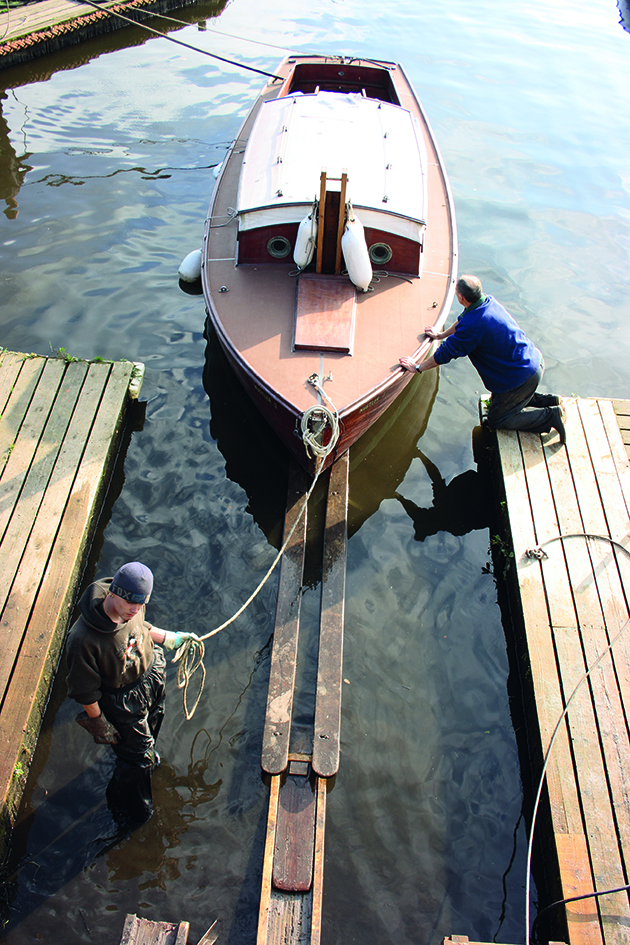 Men hauling out a wooden boat