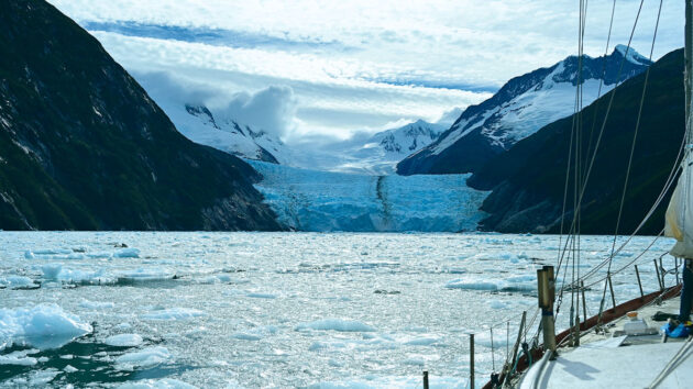 A yacht navigating icy water in the Beagle Channel