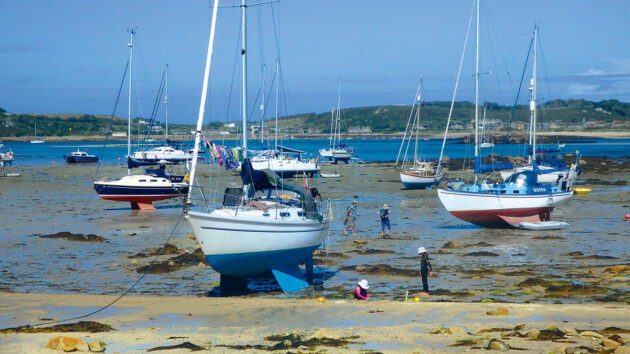 Yachts drying out on a beach in the Isles of Scilly