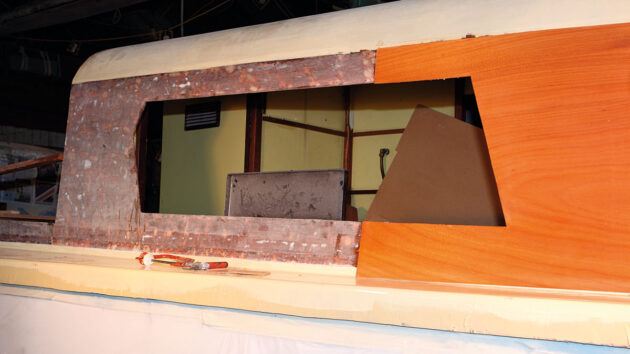 A boat being repaired with plywood veneer