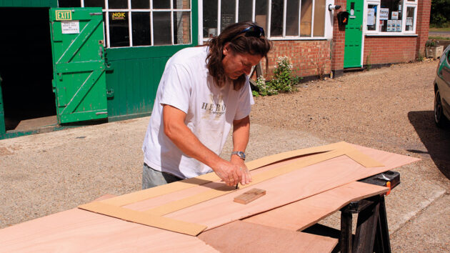 A man cutting plywood veneer