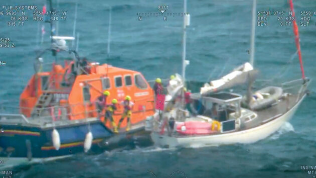 RNLI lifeboat alongside yacht with casualty onboard preparing for transfer. Credit: HM Coastguard