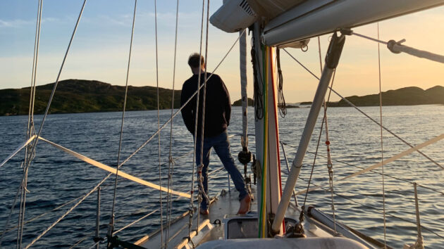 Sailor on the bow of Westerly Storm checking on anchor. Credit: Michael Skidmore