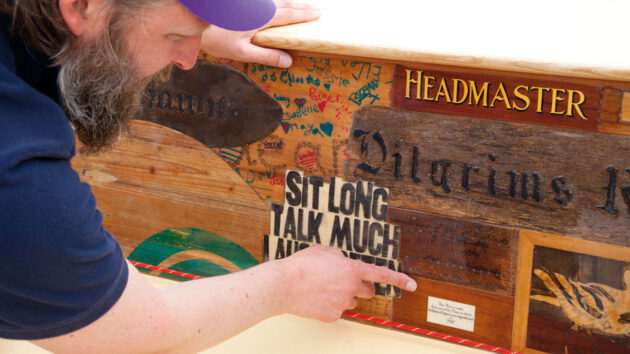A man pointing to the side of a boat
