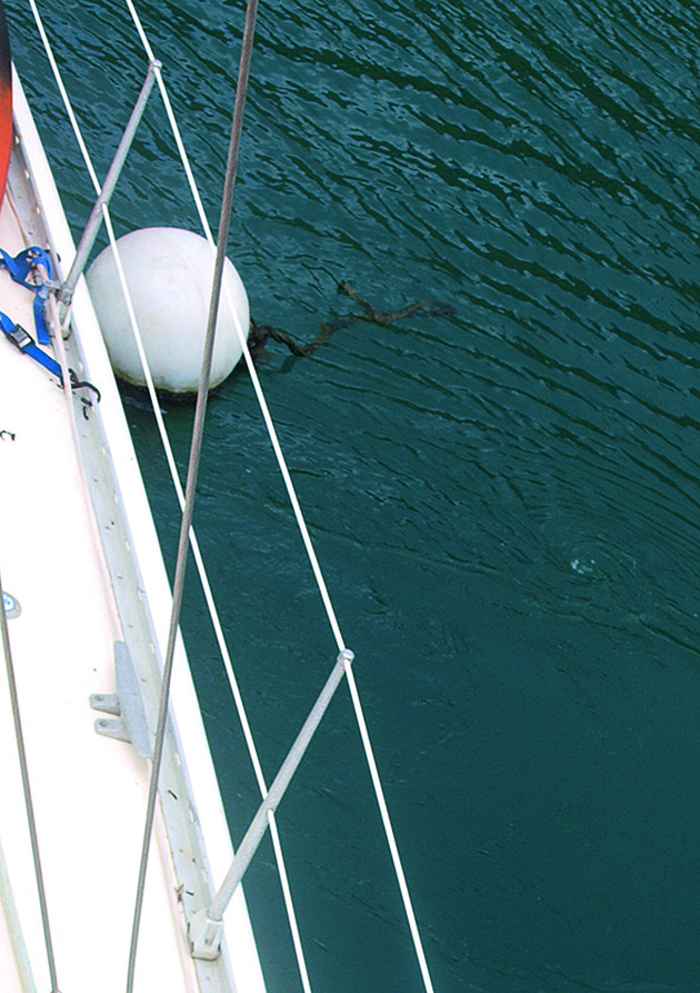 A white buoy making a boat mooring