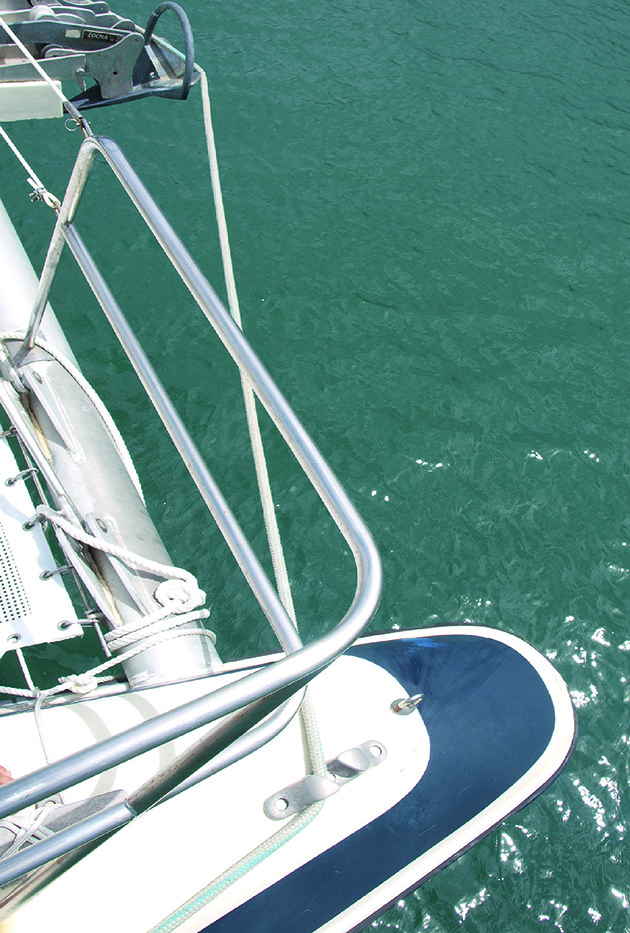 Line threaded through a cleat on a catamaran to pick up a boat mooring